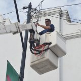 Lemoore Volunteer Fireman Nick Reed at his usual perch as he helps raise the Christmas tree downtown Sunday.